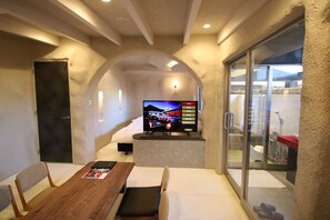 Cave Room with Open-Air Hot Spring Rock Bath | Living area | 40-inch flat-screen TV with digital channels, TV, DVD player