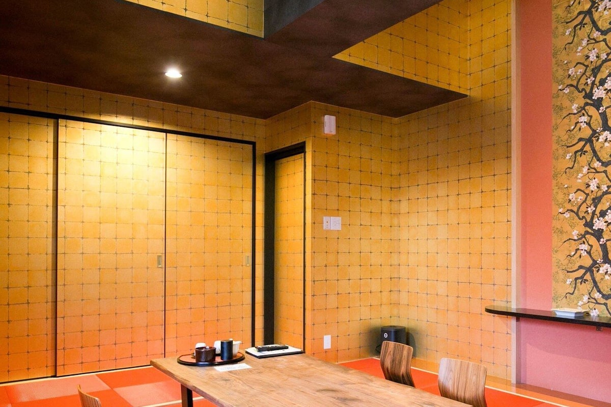 A traditional Japanese-style room with tatami flooring, a low table, and shoji screens.