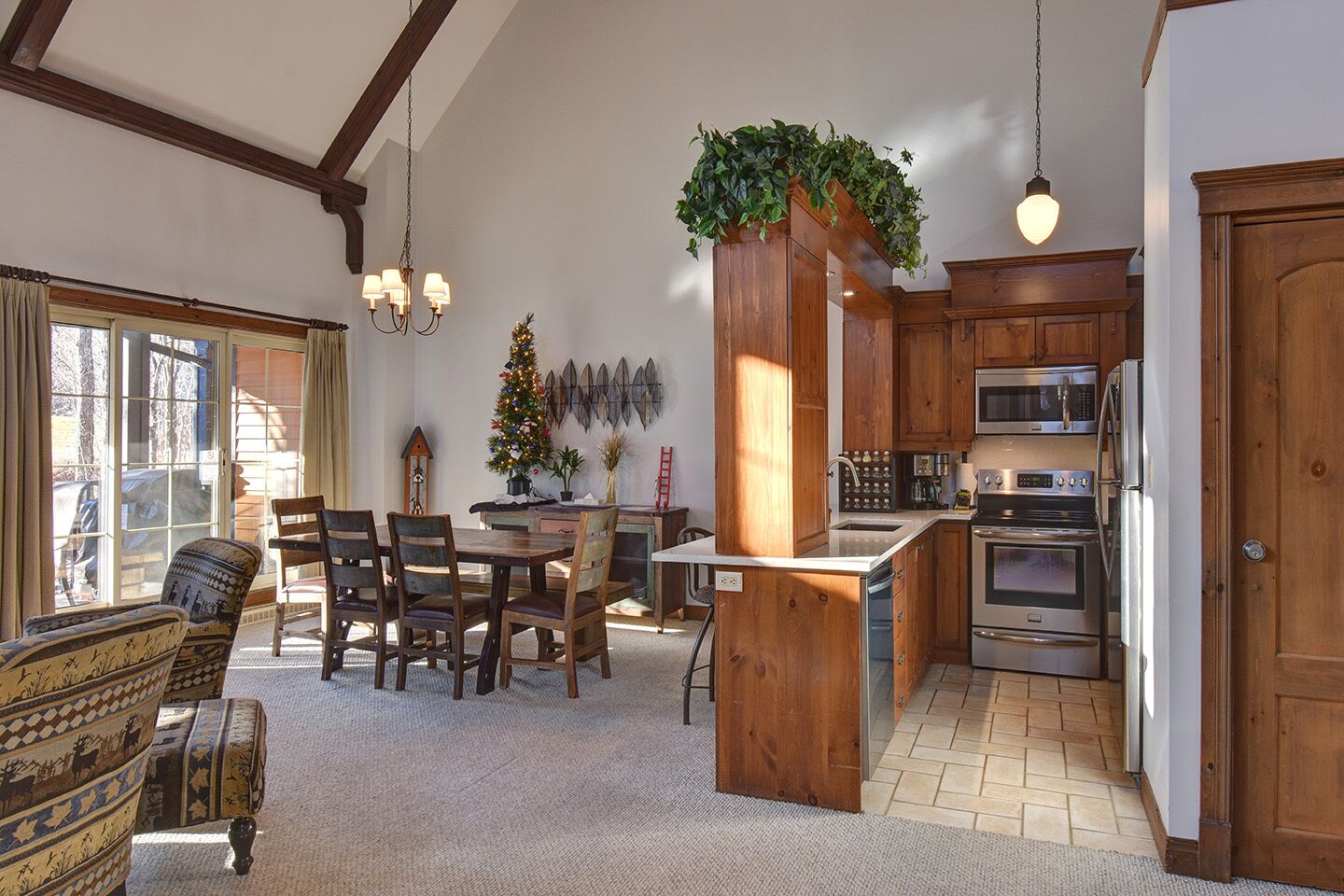 A spacious kitchen with wooden cabinets, a central island, and stainless steel appliances.