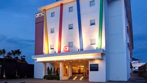 A modern hotel with a flat facade, multiple windows, and a prominent 'a' logo on the front. - Amaris Hotel Pratama Nusa Dua (Nusa Dua)