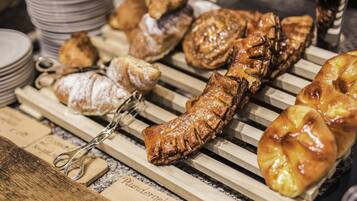 A variety of pastries displayed on wooden racks.