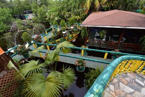 A multi-level garden with water features and potted plants.