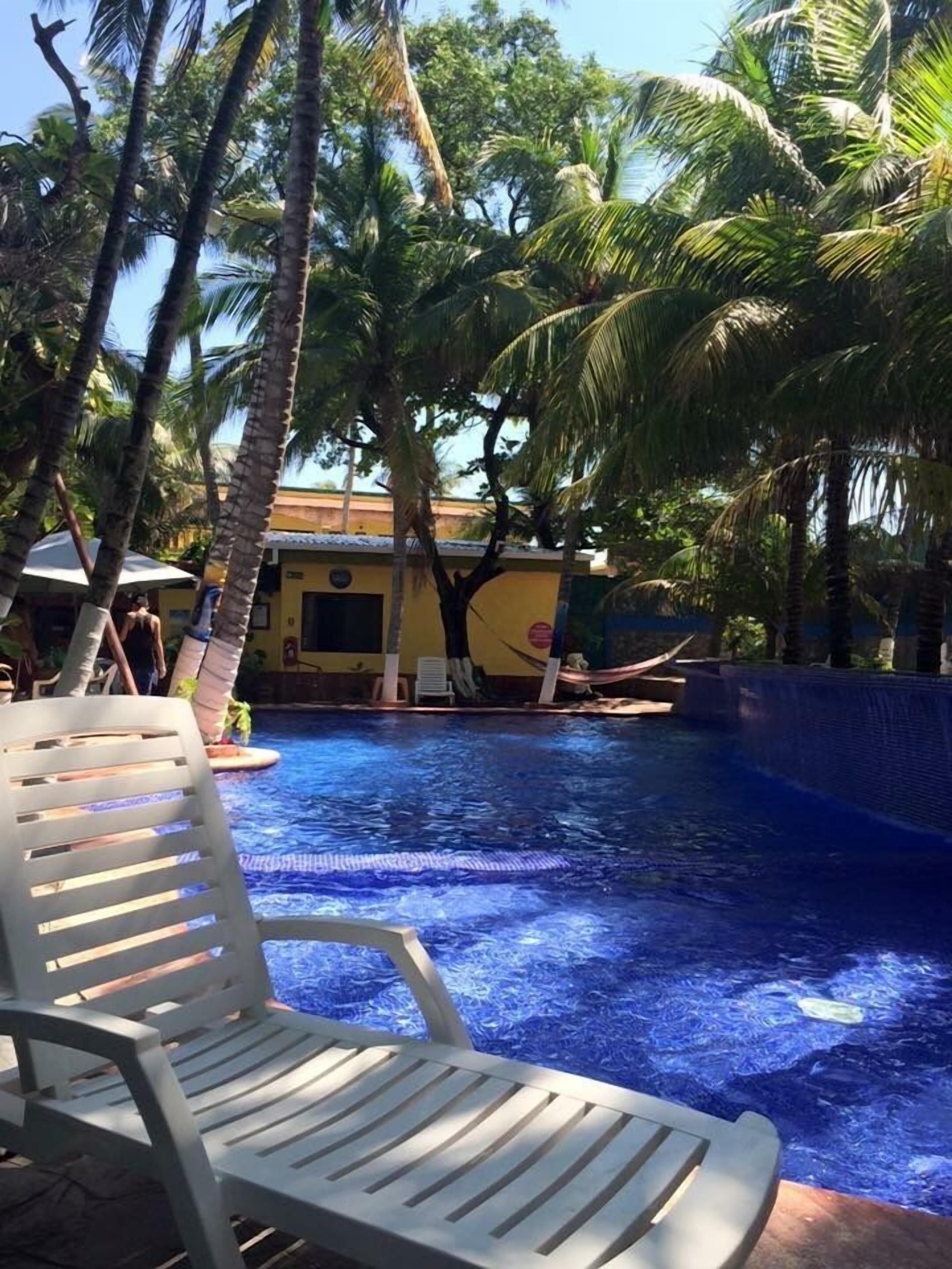 4 outdoor pools, open 8:00 AM to 10:00 PM, pool umbrellas, pool loungers