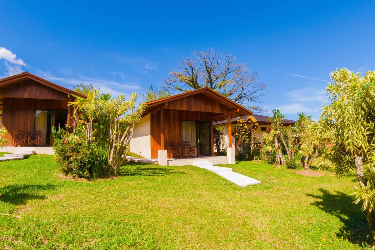 A modern two-story house with a covered porch and a well-maintained lawn.