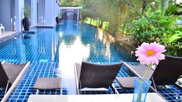 Outdoor pool, open 8:00 AM to 9:00 PM, pool loungers