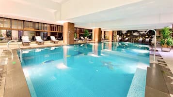 Indoor pool, pool umbrellas, pool loungers
