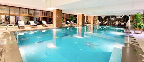 Indoor pool, pool umbrellas, sun loungers
