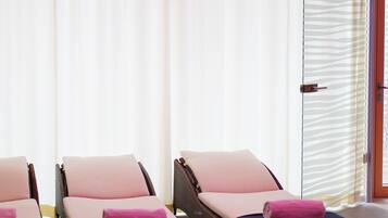 Relax in style with three lounge chairs and a large window offering a view.