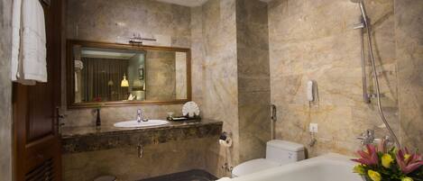 A modern bathroom with a marble sink, a bathtub, and a shower.