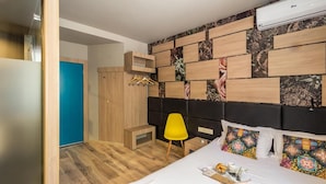A hotel room with a bed, a bedside table, a chair, a wardrobe, and a wardrobe with a mirror. - Hotel Allur (Plovdiv)