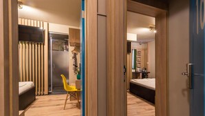 A hotel room with a bed, a desk, a chair, and a wardrobe. - Hotel Allur (Plovdiv)