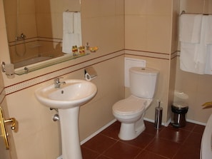 A bathroom with a sink, toilet, and a glass shower enclosure. - Hotel Brilliantin (Sliven)