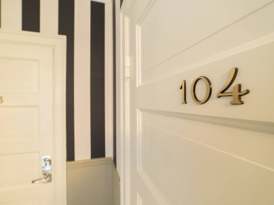 A door with the number 103 and a wall with the number 104.