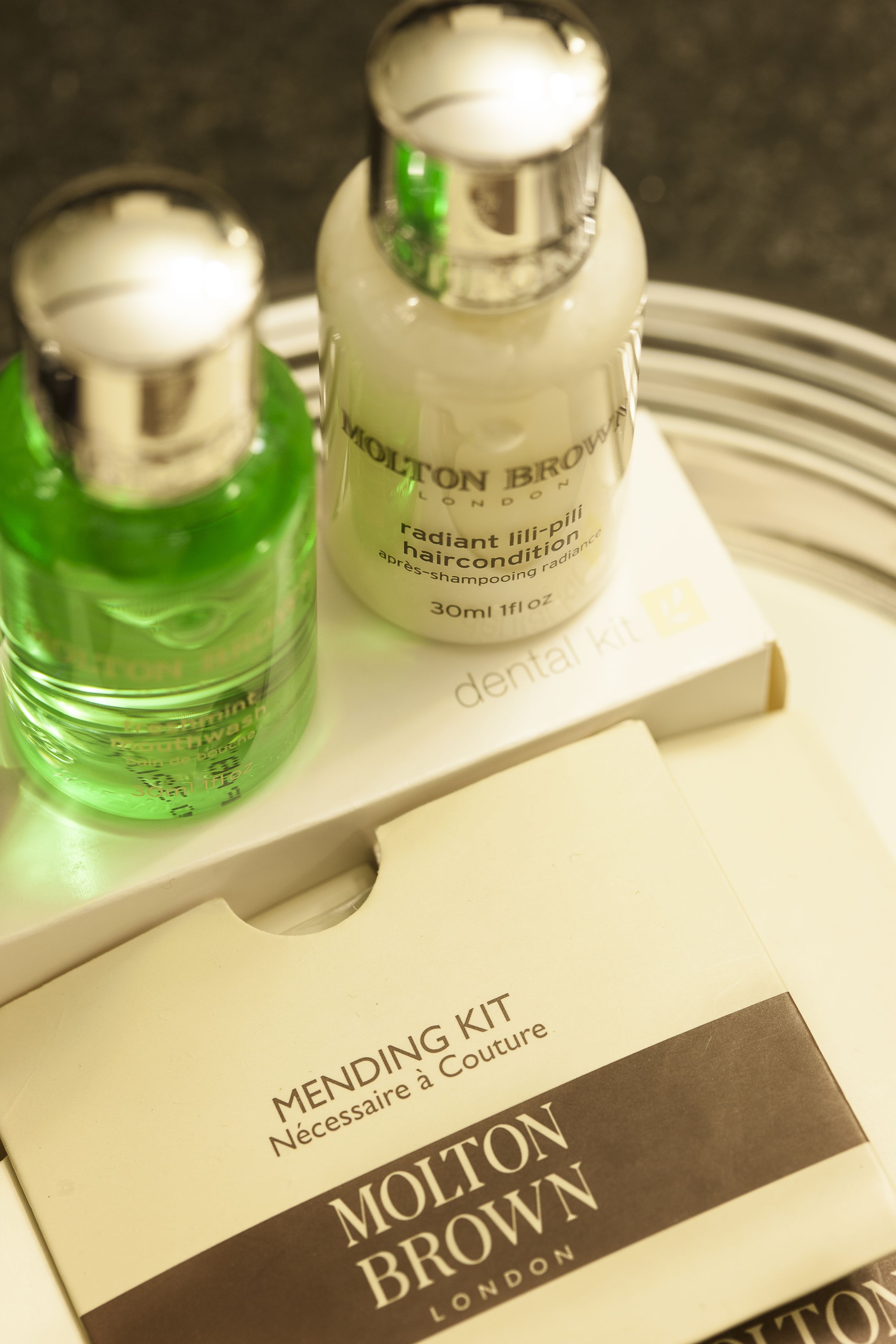 A dental kit with a green liquid and a white bottle labeled "MOLTON BROWN" on a tray.