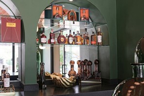A liquor store with shelves of bottles and a display of wine glasses.