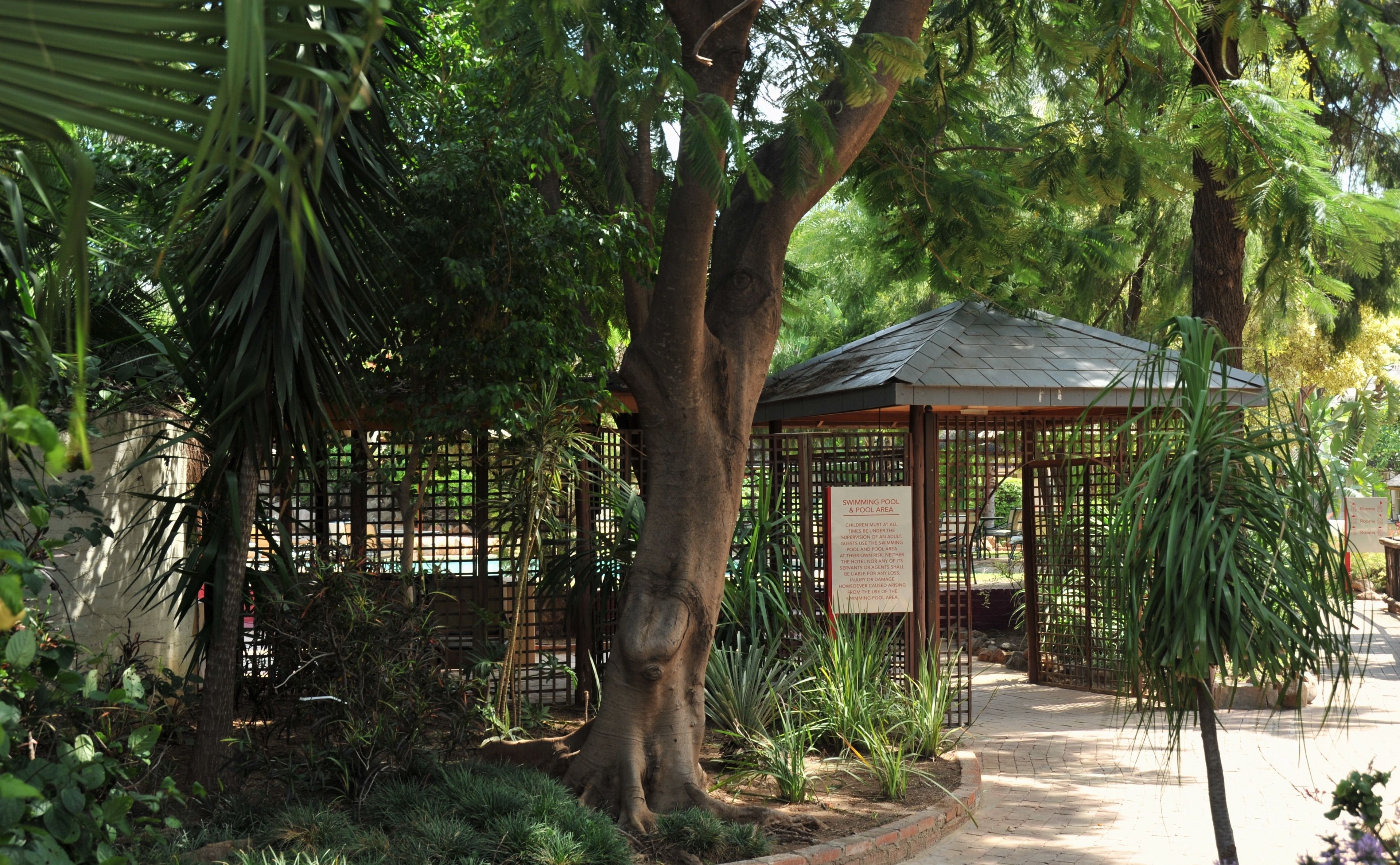 A gazebo with a sign indicating a swimming pool and pool area.