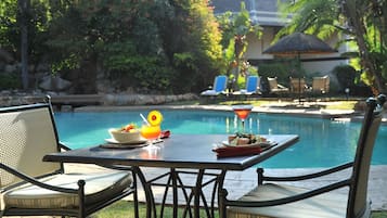 Outdoor pool, open 6:00 AM to 6:00 PM, pool umbrellas, pool loungers