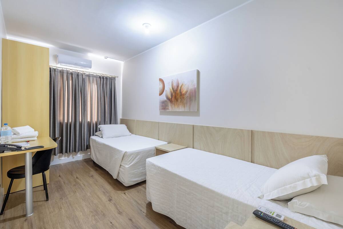 Twin Room | Minibar, desk, laptop workspace, blackout drapes