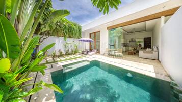 Relax in a serene outdoor space with a swimming pool and enjoy a well-equipped kitchen and comfortable living areas.