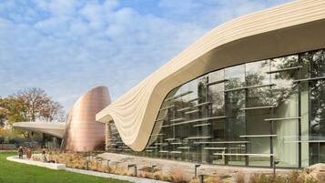 A modern building with curved architecture and large glass windows.