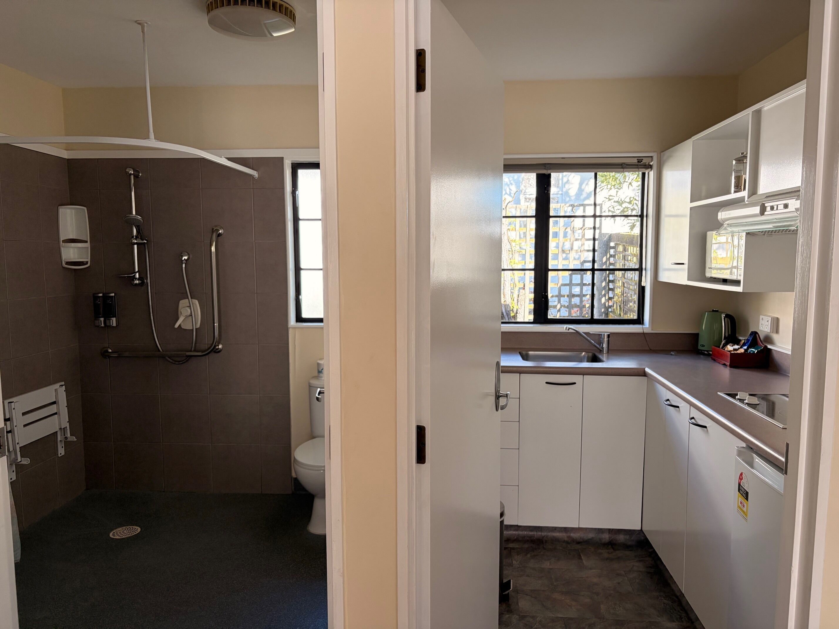 A bathroom with a shower, toilet, and sink.