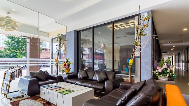 A modern hotel lobby with leather sofas, a white coffee table, and large windows offering a view of the city. - Dolphin Hotel, Chow Kit Kuala Lumpur (Kuala Lumpur)