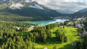 A mountainous landscape with a lake, forested areas, and a golf course. - Kulm Hotel St. Moritz (St. Moritz)