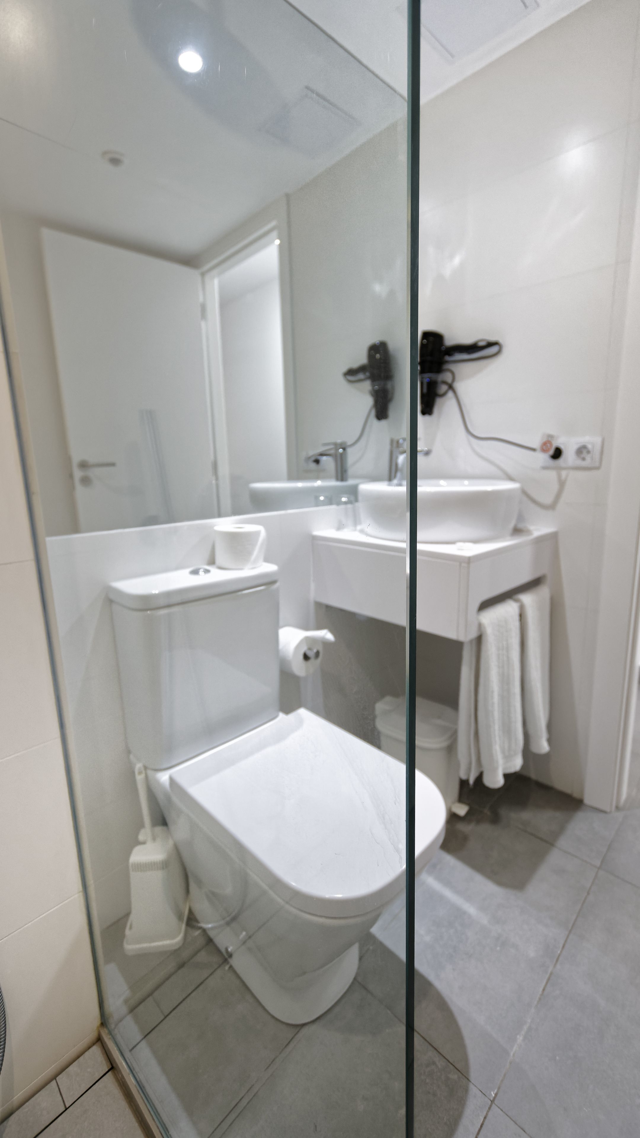 Une salle de bain moderne équipée de toilettes, d’un bidet et d’un lavabo.