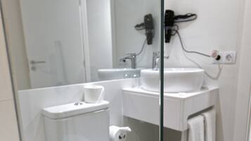 Une salle de bain moderne équipée de toilettes, d’un bidet et d’un lavabo.