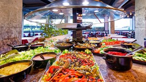 A buffet with various dishes and a glass enclosure.