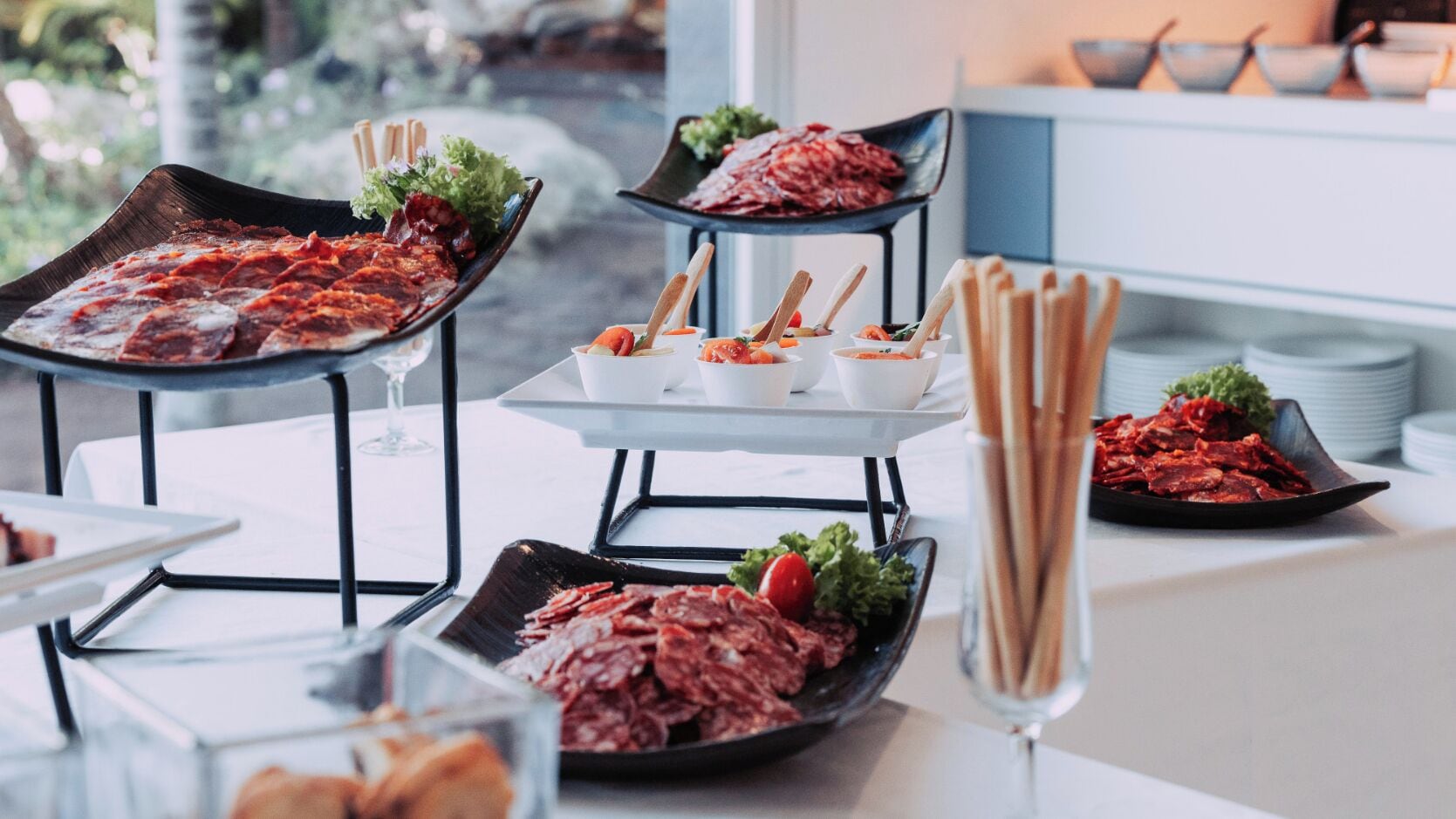A buffet setup with various dishes and utensils.