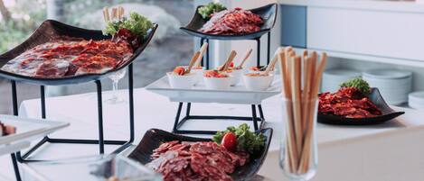 A buffet setup with various dishes and utensils.