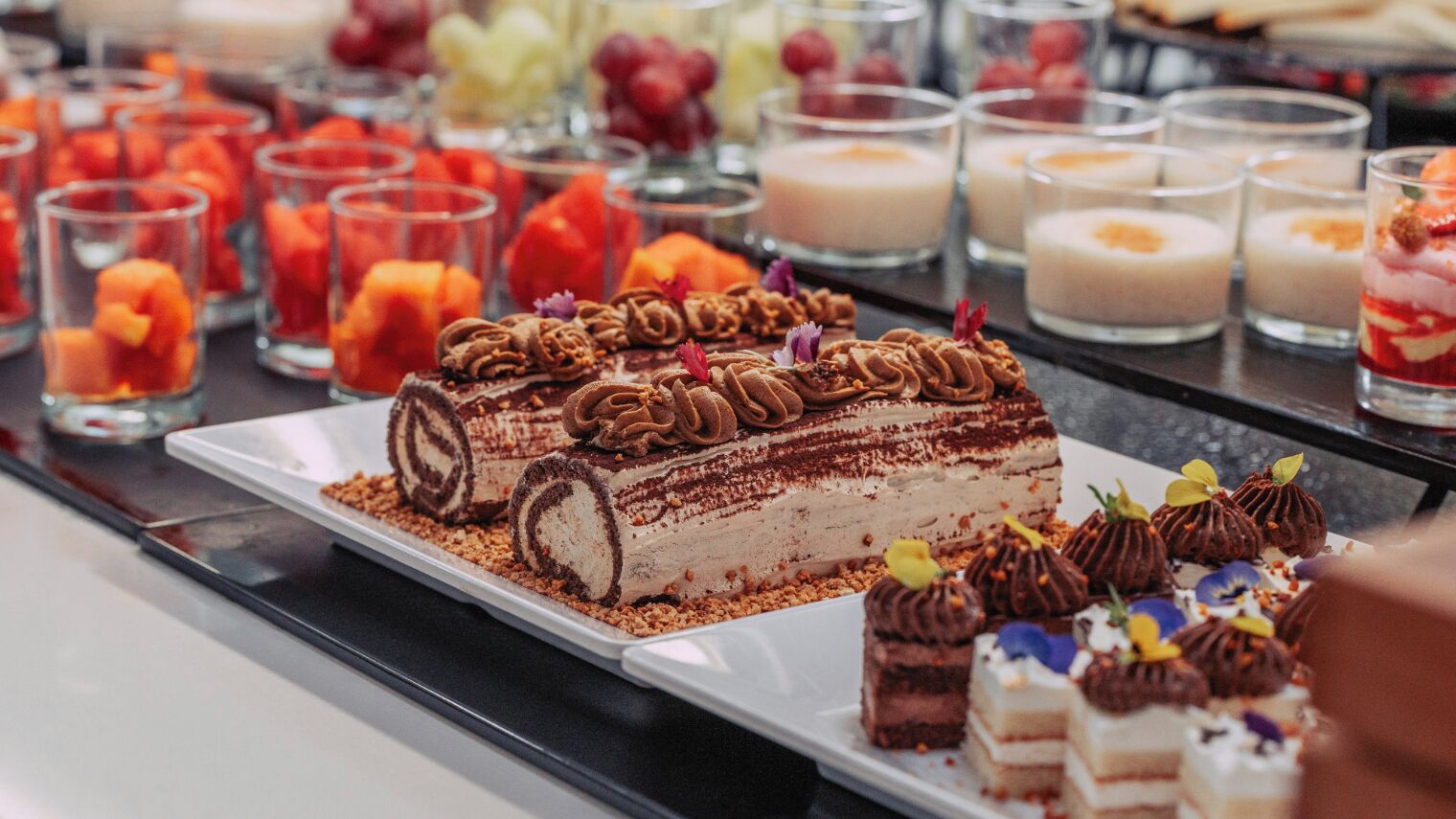 A dessert display with various cakes and desserts.