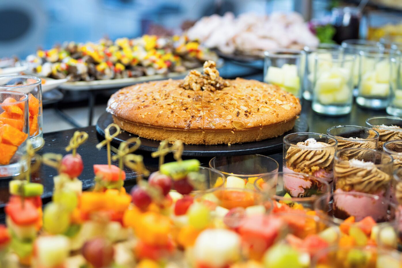 A dessert table with a variety of sweets and a large cake.