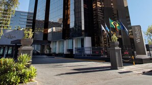 Un edificio alto y moderno con ventanas de vidrio reflectante y un letrero llamativo que dice 'Windsor Plaza'.