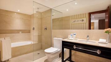 A modern bathroom with a glass-enclosed shower, a toilet, and a vanity with a sink and mirror.
