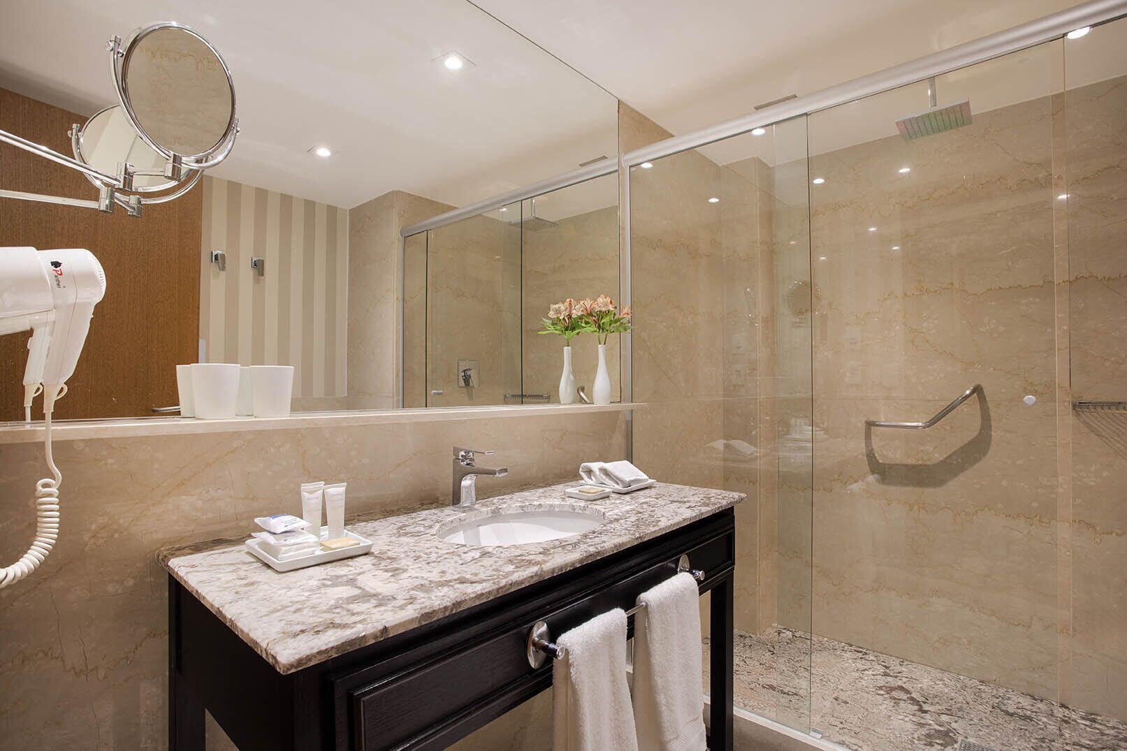 shower, hair dryer, slippers, towels