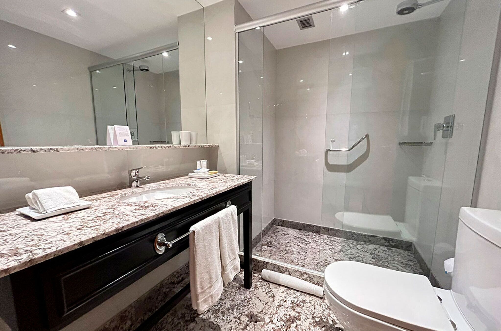 shower, hair dryer, slippers, towels