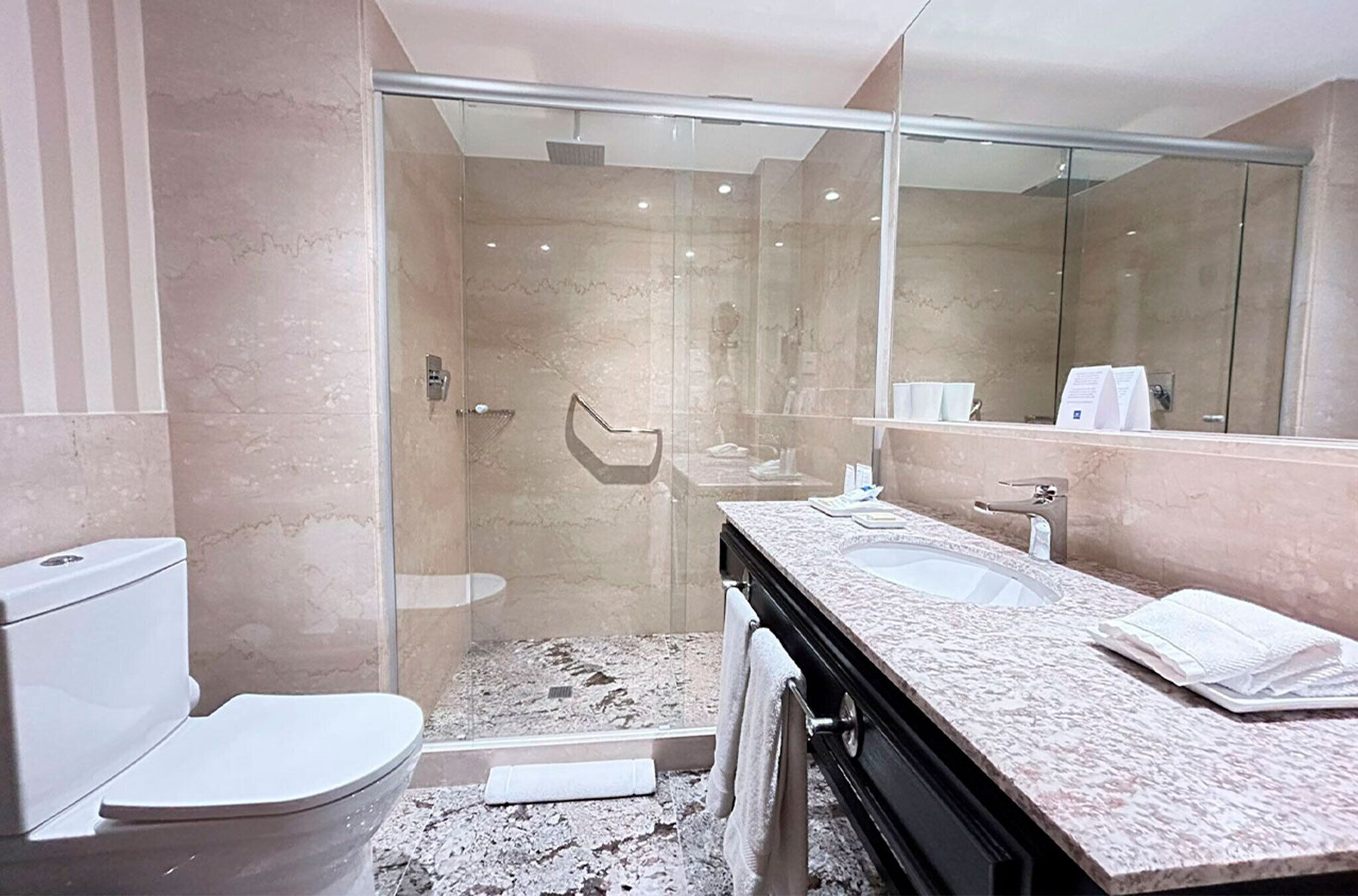 shower, hair dryer, slippers, towels