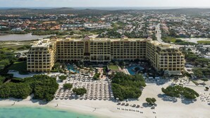 A large hotel with multiple buildings, a beach, and a pool area. - The Ritz-Carlton, Aruba (Noord)