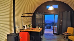 A cozy interior with a kitchen area, a dining table, and a seating area.