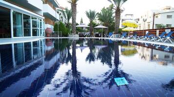 Indoor pool, outdoor pool, open 8 AM to 8 PM, pool umbrellas