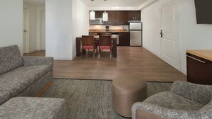 A modern apartment with a living room, kitchenette, and dining area. - TownePlace Suites by Marriott Thunder Bay (Thunder Bay)