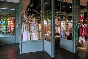 A clothing store with mannequins displaying various outfits.