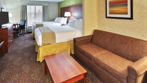 A hotel room with a bed, a sofa, a desk, and a television. - Holiday Inn Express Hotel & Suites Frankenmuth by IHG (Frankenmuth)
