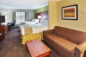 A hotel room with a bed, a sofa, a desk, and a television. - Holiday Inn Express Hotel & Suites Frankenmuth by IHG (Frankenmuth)