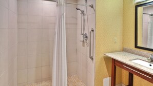 A bathroom with a shower, a sink, and a mirror. - Holiday Inn Express Hotel & Suites Frankenmuth by IHG (Frankenmuth)