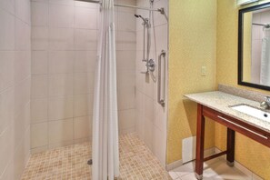 A bathroom with a shower, a sink, and a mirror. - Holiday Inn Express Hotel & Suites Frankenmuth by IHG (Frankenmuth)