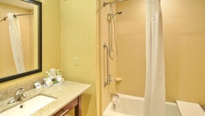 A bathroom with a sink, mirror, shower, and bathtub. - Holiday Inn Express Hotel & Suites Frankenmuth by IHG (Frankenmuth)
