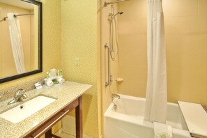 A bathroom with a sink, mirror, shower, and bathtub. - Holiday Inn Express Hotel & Suites Frankenmuth by IHG (Frankenmuth)